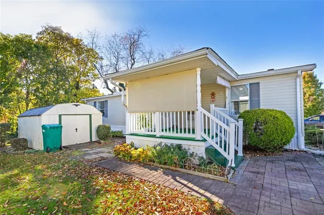 a view of a house with a small yard and plants