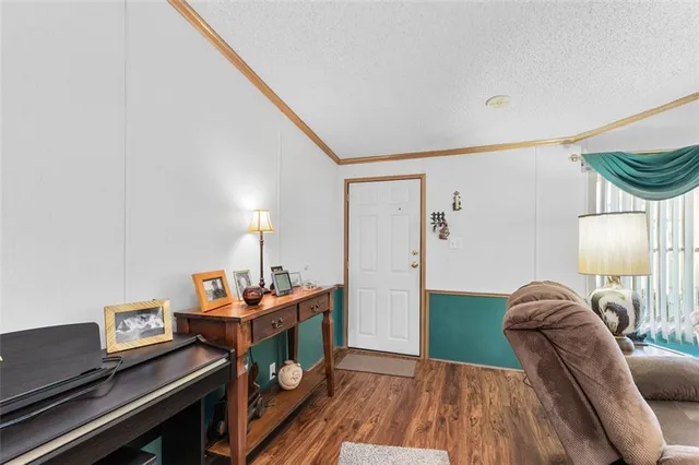 a bedroom with furniture and a wooden floor