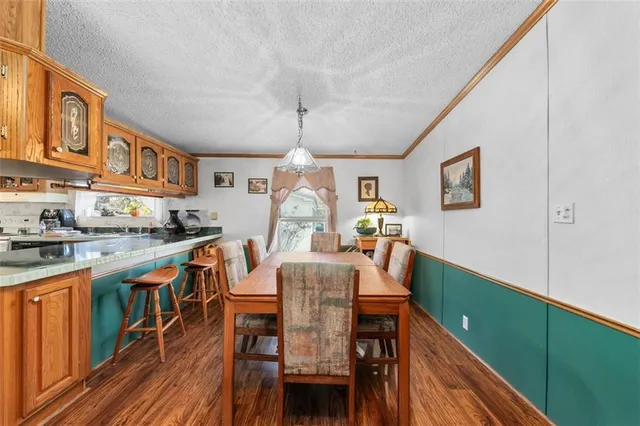 a dining room with furniture and wooden floor