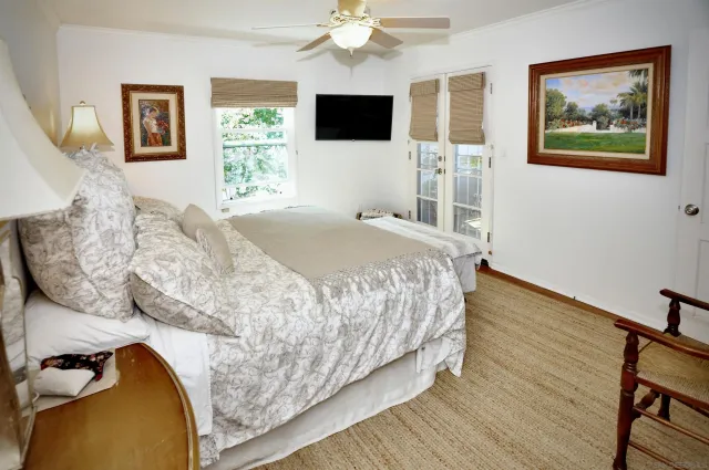 a bedroom with a bed and a flat screen tv