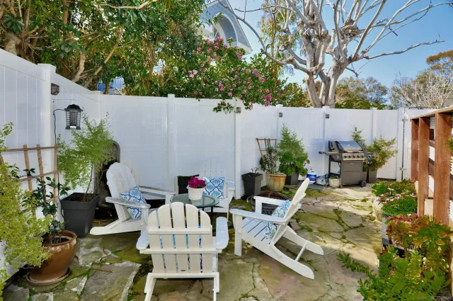 a backyard of a house with table and chairs