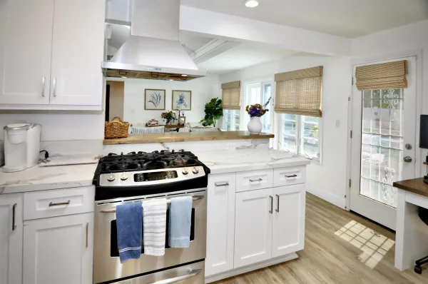a kitchen with granite countertop a stove and a sink