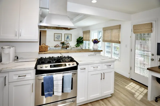 a kitchen with granite countertop a stove and a sink