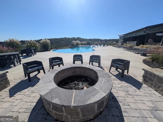 a view of roof deck with couches and city view