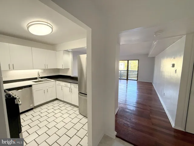 a kitchen with a refrigerator and a sink