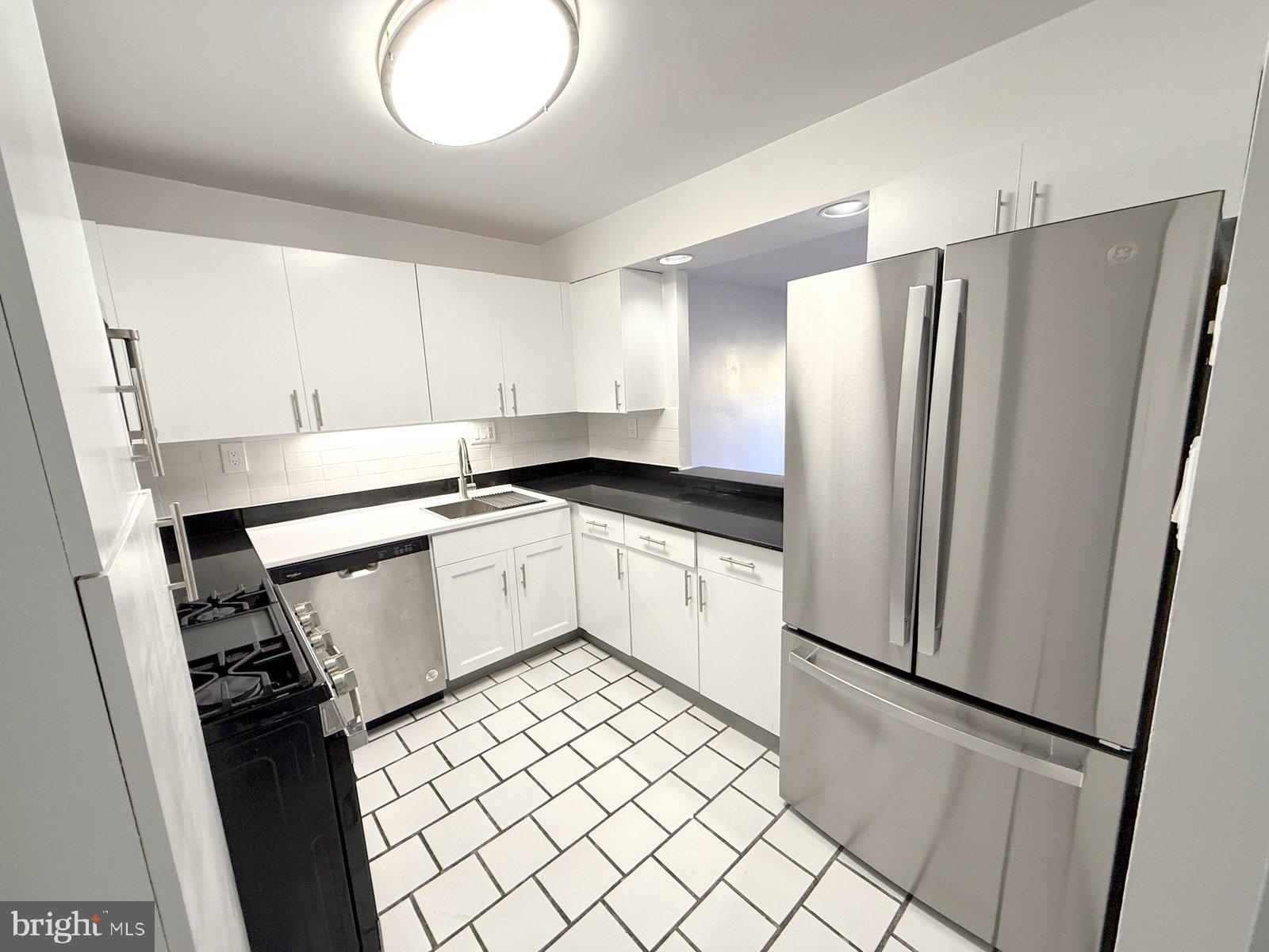 606 Cooper Landing Road, Unit A3E Cherry Hill, NJ 08002 - Photo 3 of 17 a kitchen with a refrigerator and a sink
