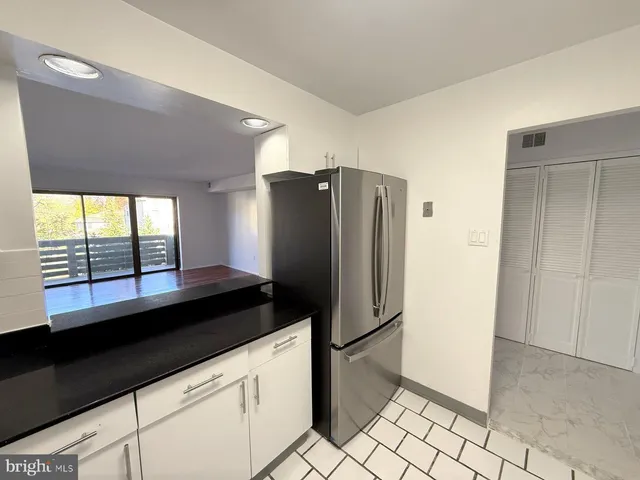 a kitchen with granite countertop a refrigerator and a stove