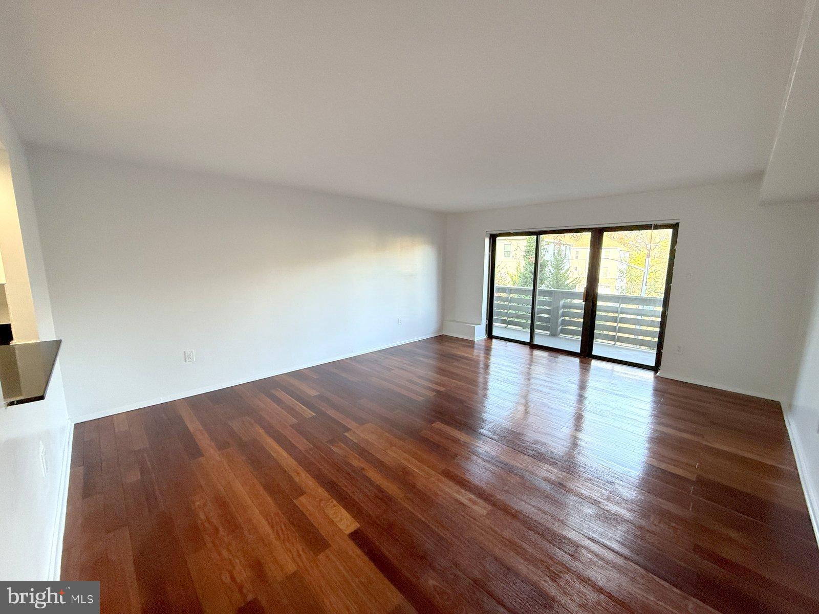 606 Cooper Landing Road, Unit A3E Cherry Hill, NJ 08002 - Photo 8 of 17 a view of an empty room with wooden floor and a window