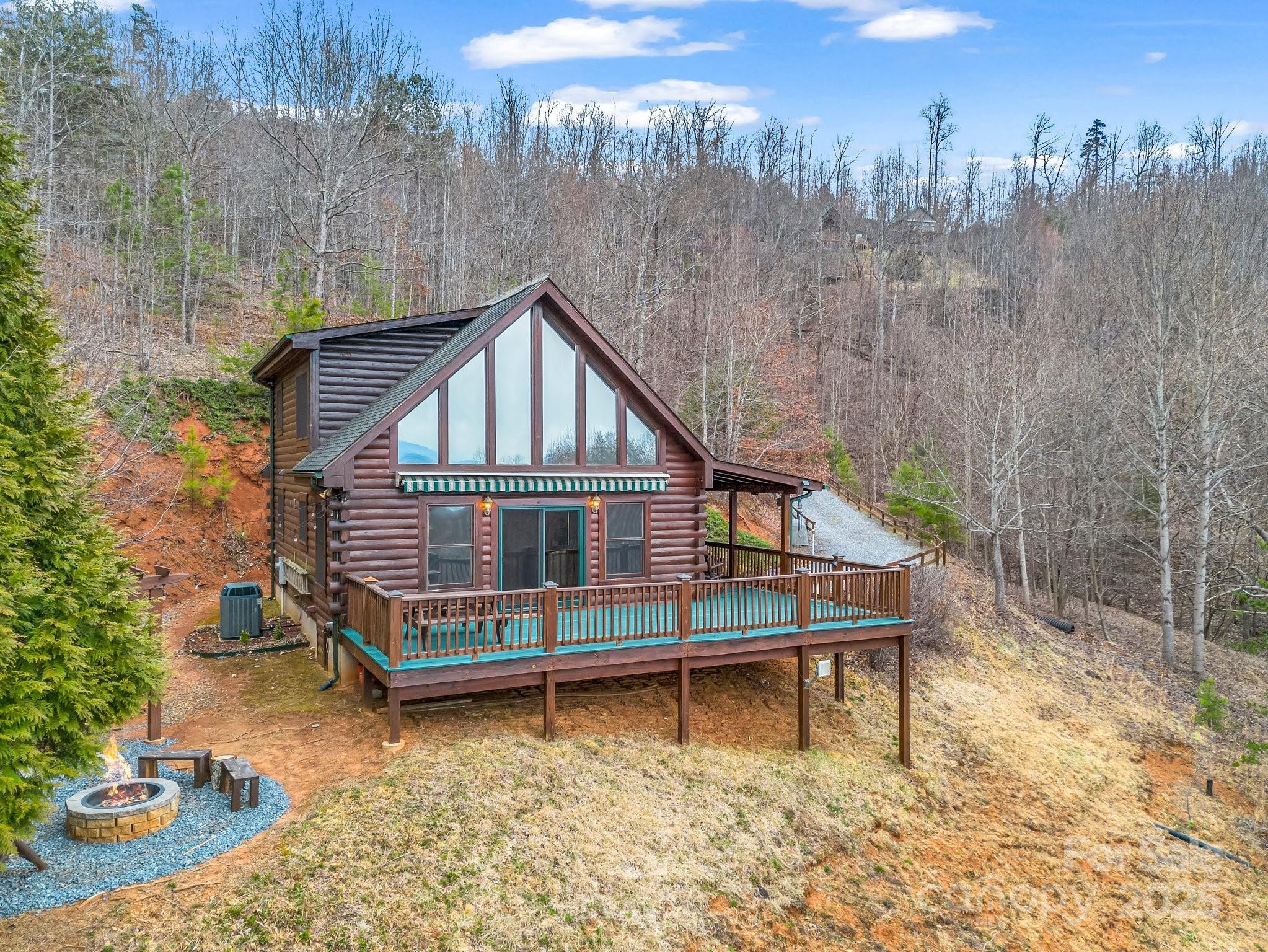 206 Dennis Ridge Bostic, NC 28018 - Photo 5 of 40 a wooden house with a bench in front of it