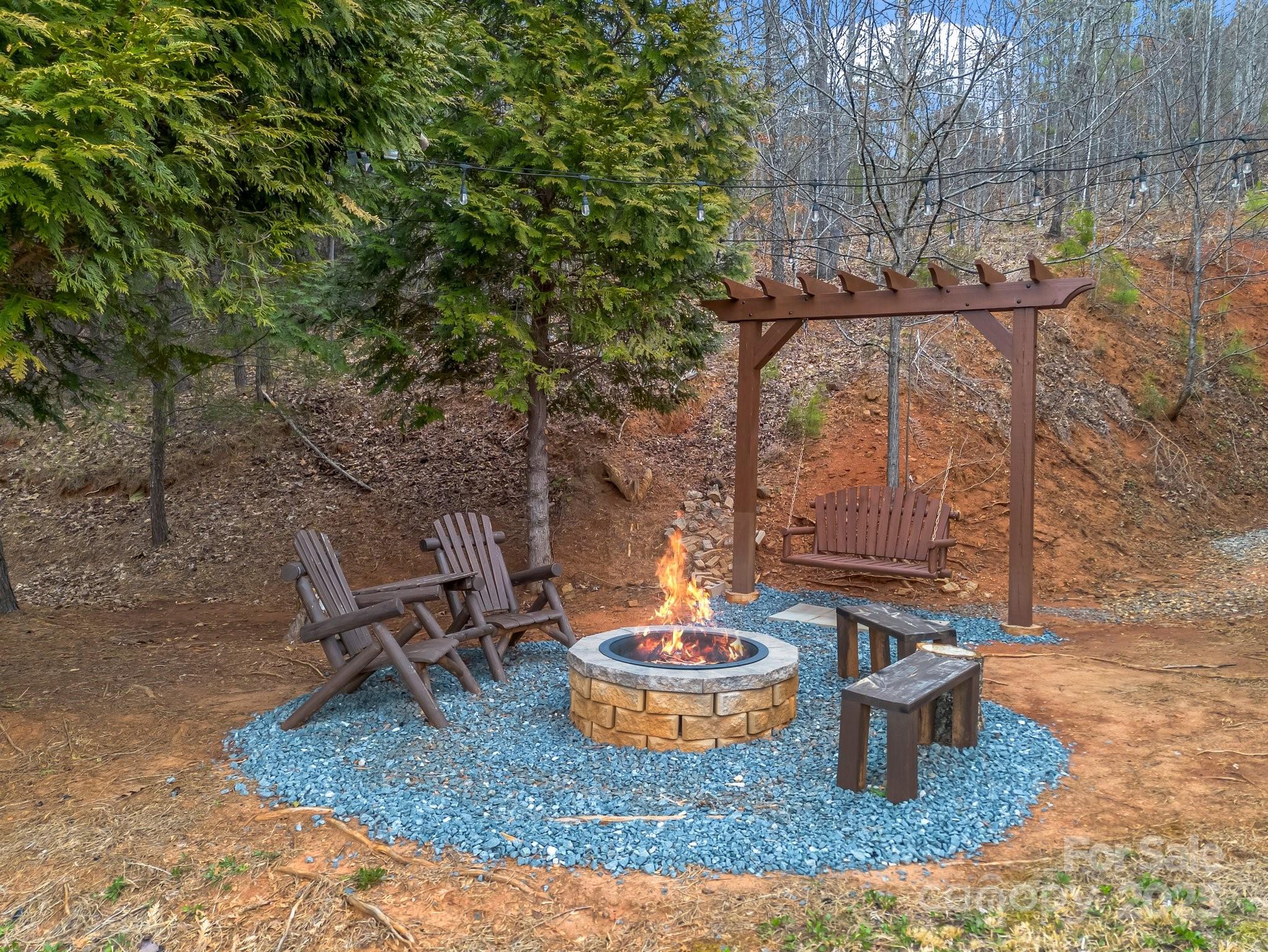 206 Dennis Ridge Bostic, NC 28018 - Photo 10 of 40 a view of a backyard with table and chairs potted plants and large tree