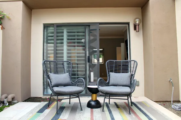 a balcony with wooden floor and a potted plant