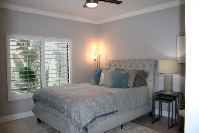 a bedroom with a bed and a night stand