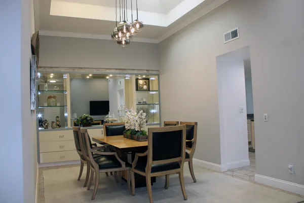 a view of a dining room with furniture and chandelier
