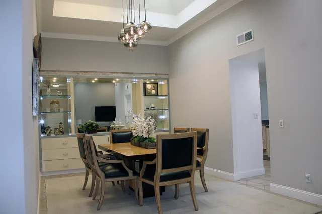 a view of a dining room with furniture and chandelier