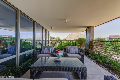 a view of a chairs and table in the patio