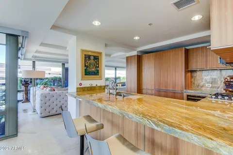 a living room with furniture and a floor to ceiling window