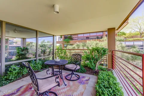 a bedroom with a bed couch and a large window