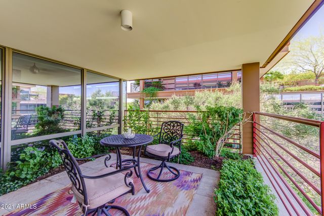 a bedroom with a bed couch and a large window
