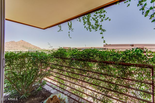 a large white kitchen with a sink and dishwasher a refrigerator with wooden floor