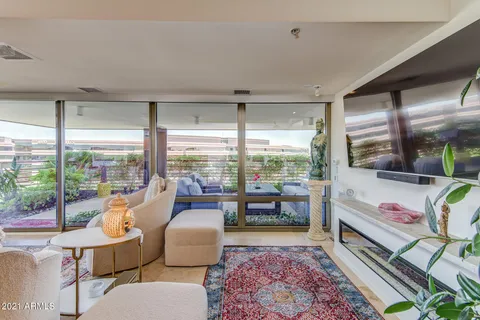 a bedroom with furniture and a large window