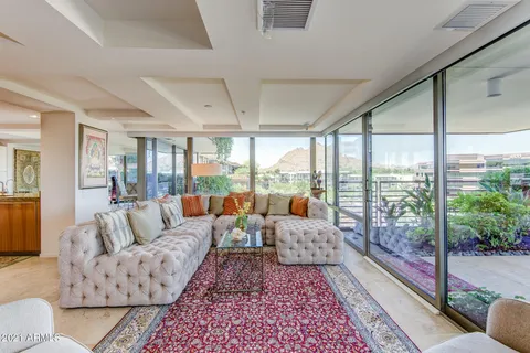 a living room with furniture and large windows