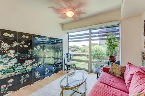 a view of kitchen with stainless steel appliances kitchen island wooden cabinets and fireplace