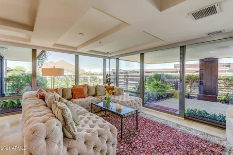 a living room with furniture and a floor to ceiling window