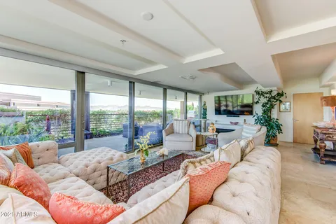 a living room with furniture and a floor to ceiling window