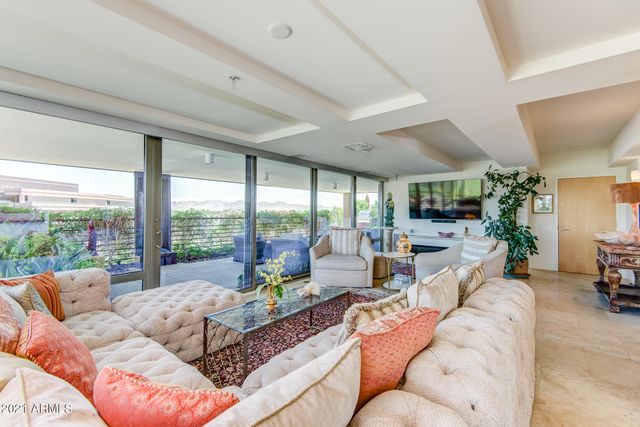 a living room with furniture and a floor to ceiling window
