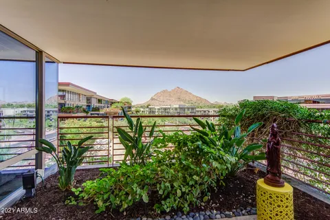 a view of a chairs and table in the back yard of the house