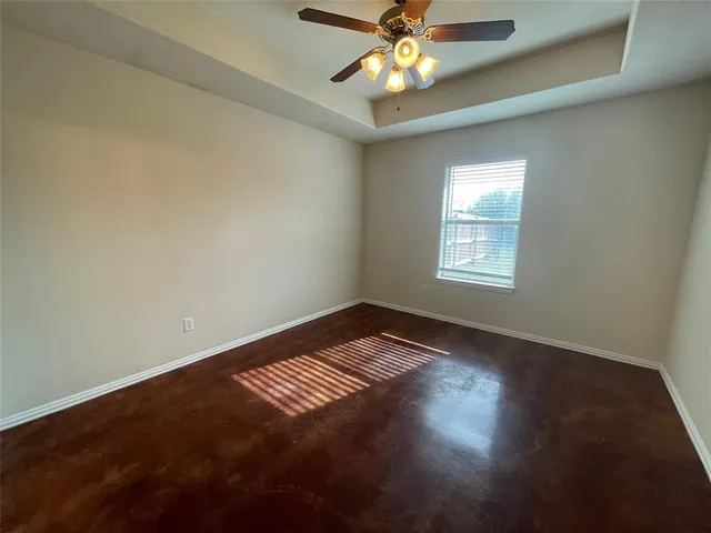 an empty room with closet and windows