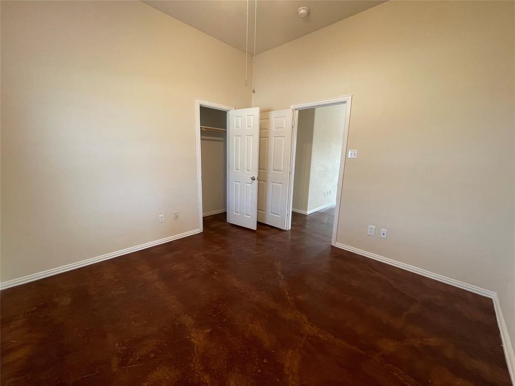 100 Crossbow Court, Unit 102 Weatherford, TX 76088 - Photo 12 of 21 an empty room with closet and windows