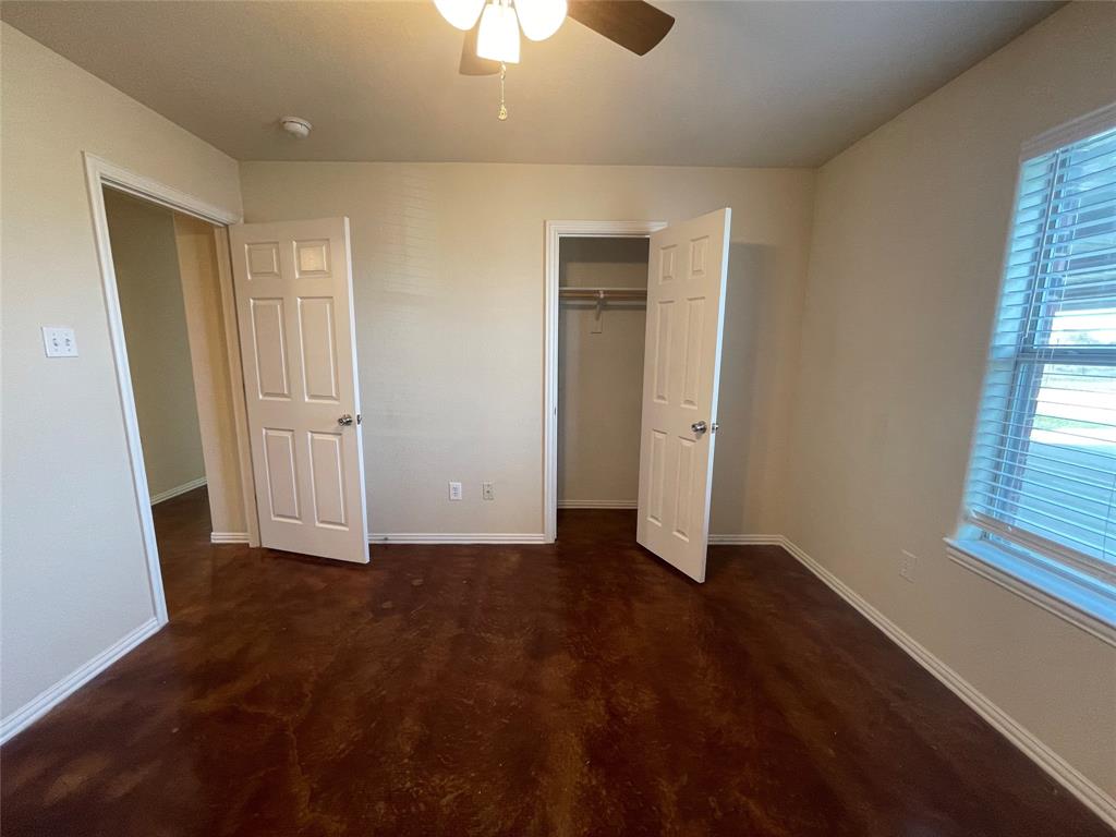 100 Crossbow Court, Unit 102 Weatherford, TX 76088 - Photo 14 of 21 an empty room with closet and windows