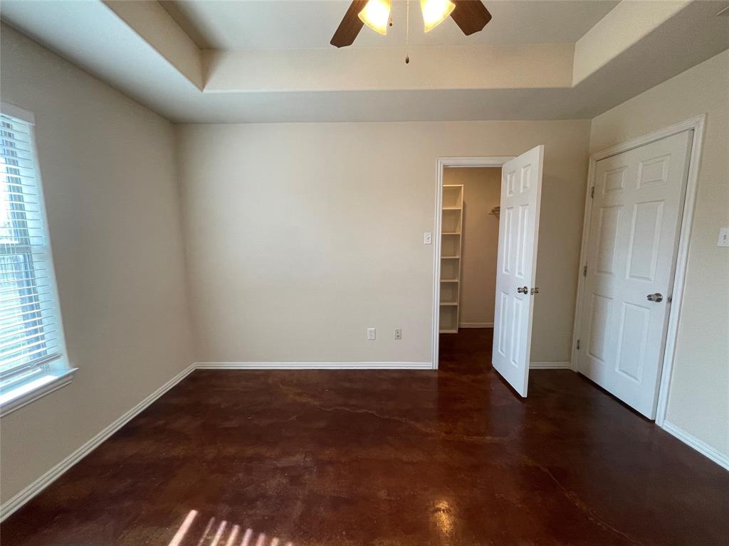 100 Crossbow Court, Unit 102 Weatherford, TX 76088 - Photo 15 of 21 an empty room with wooden floor and windows