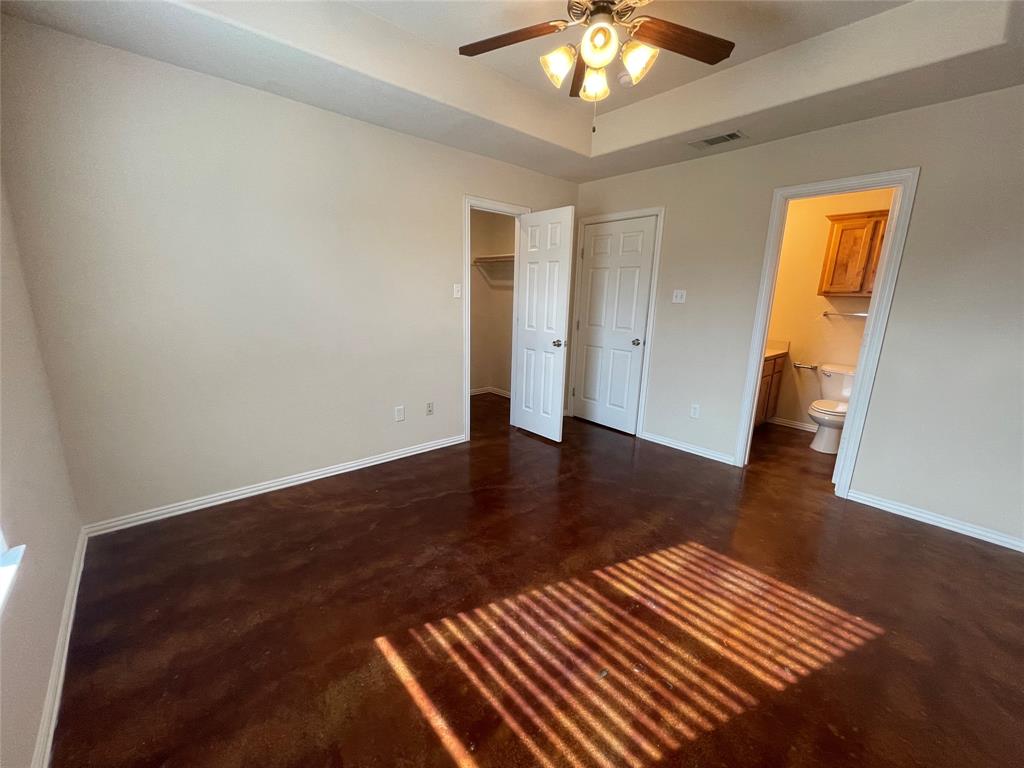 100 Crossbow Court, Unit 102 Weatherford, TX 76088 - Photo 18 of 21 a view of a livingroom with wooden floor and a ceiling fan