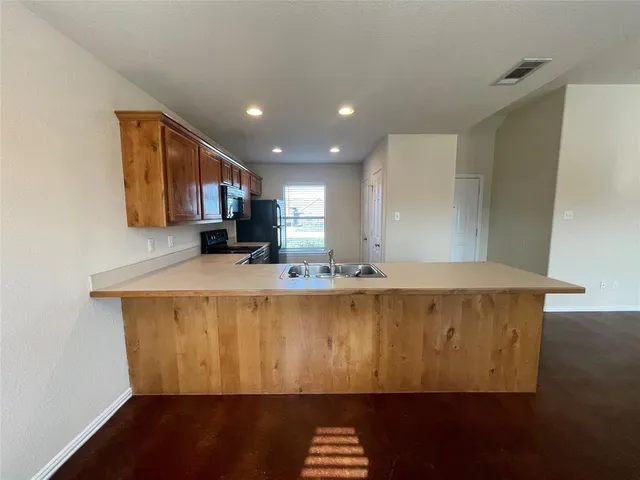 a kitchen with a sink and a stove top oven