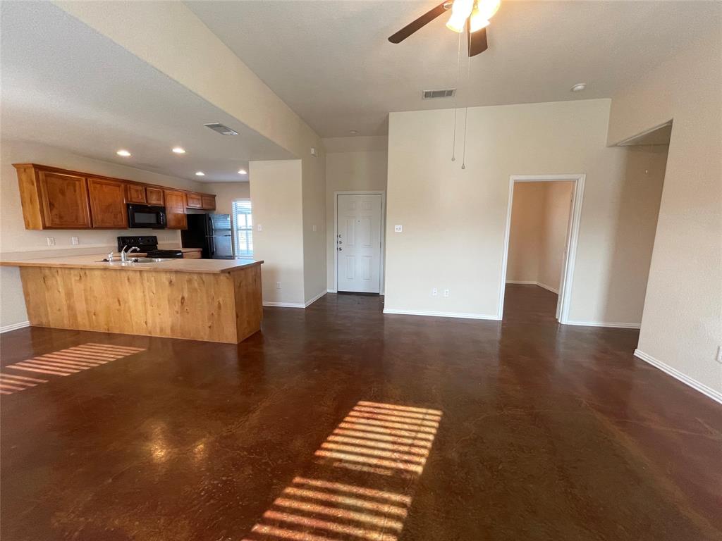 100 Crossbow Court, Unit 102 Weatherford, TX 76088 - Photo 7 of 21 a view of kitchen with cabinets and wooden floor