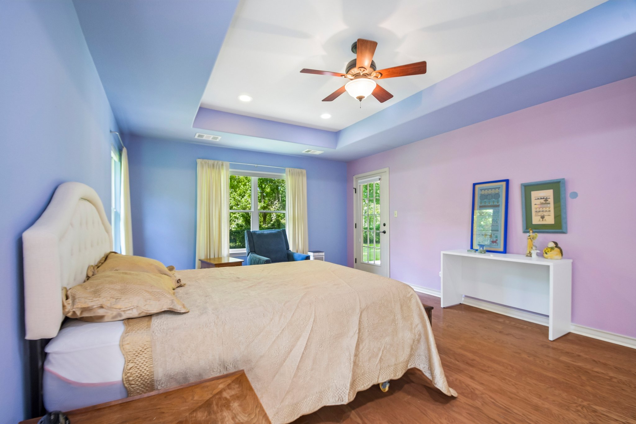 307 West 4th Street Elgin, TX 78621 - Photo 17 of 40 Bedroom featuring wood-finish flooring, a tray ceiling with recessed lighting, and a ceiling fan