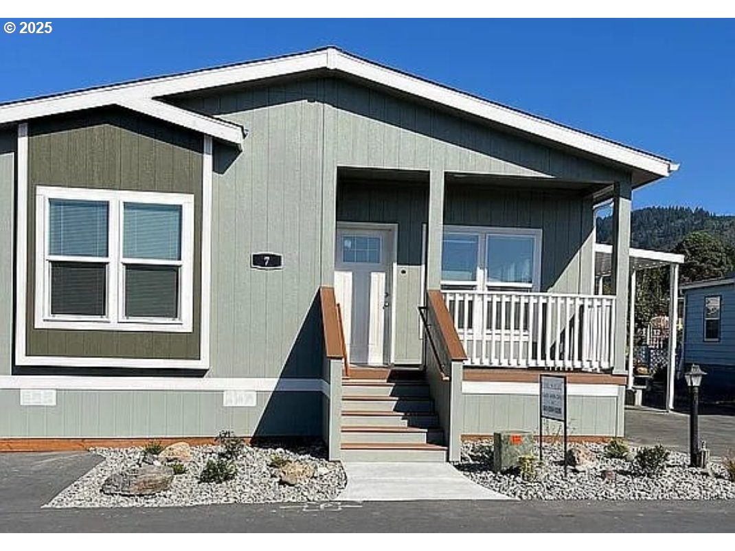 15889 Sunset Strip, Unit 7 Brookings, OR 97415 - Photo 1 of 10 a front view of a house with a porch