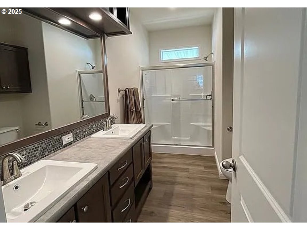 15889 Sunset Strip, Unit 7 Brookings, OR 97415 - Photo 8 of 10 a bathroom with a sink and a mirror