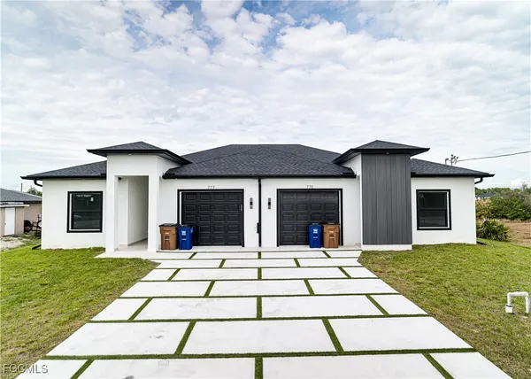 a front view of a house with a yard