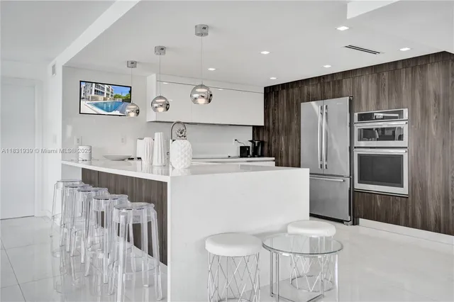 a kitchen with stainless steel appliances granite countertop a refrigerator and a stove