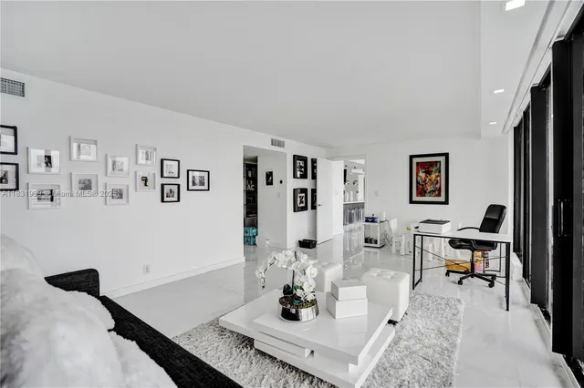 a living room with furniture and floor to ceiling window
