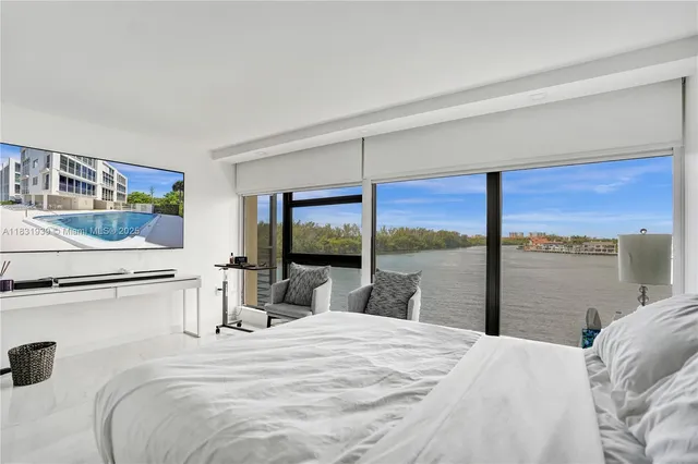 a living room with furniture and floor to ceiling window