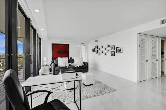 a bedroom with a large bed and a large window