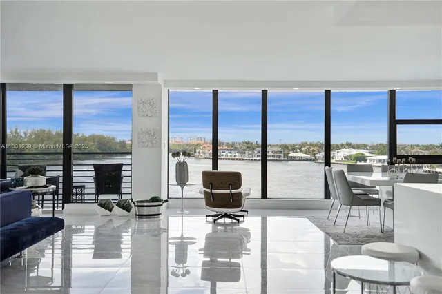 a living room with furniture and a floor to ceiling window