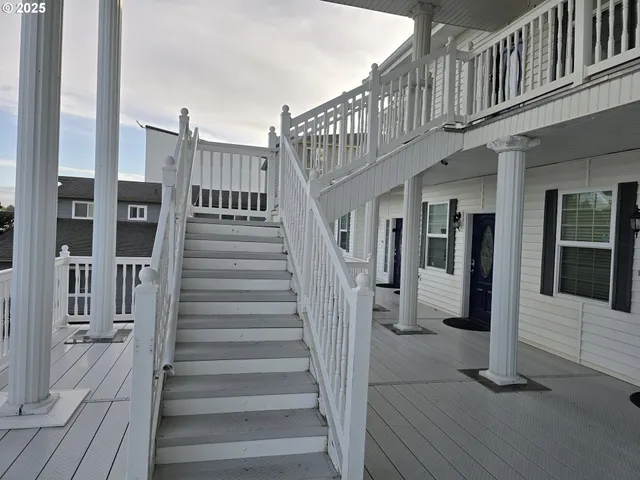 a kitchen with stainless steel appliances granite countertop a refrigerator a stove a sink and a stove