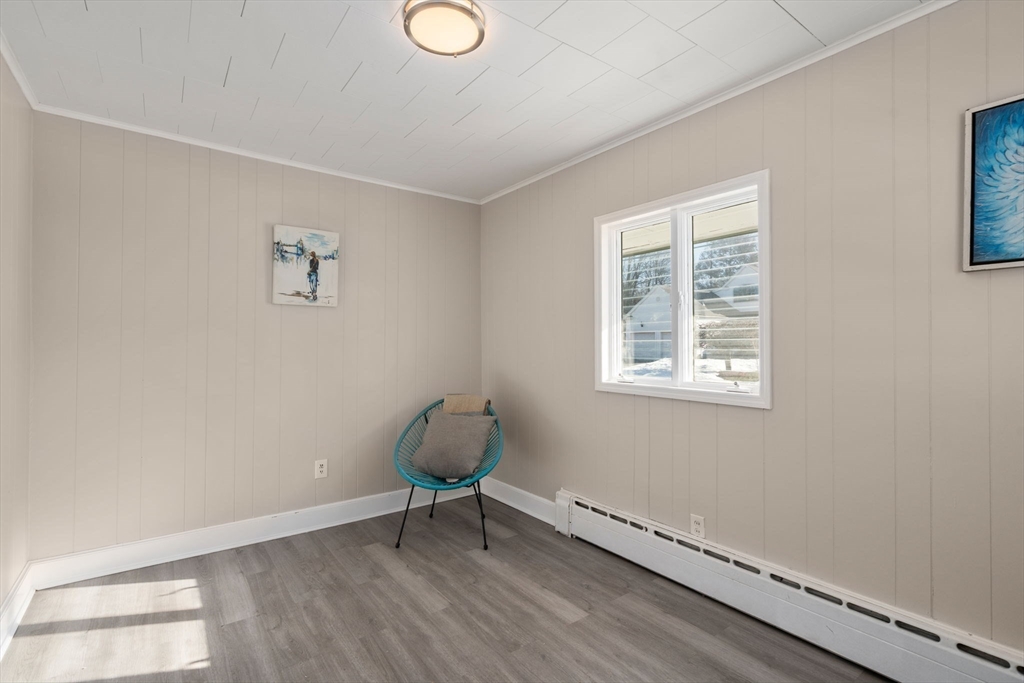 27 Dresser Street Webster, MA 01570 - Photo 12 of 33 a view of an empty room with a window and wooden floor