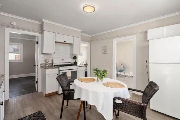a kitchen with a table chairs and a refrigerator