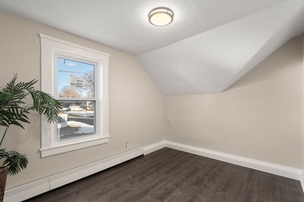 27 Dresser Street Webster, MA 01570 - Photo 19 of 33 an empty room with wooden floor and windows